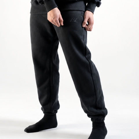 Front of the A7 Veil overfit joggers in stealth/black. Worn by a man and unisex sizing, this strength sports apparel is meet day apparel for traveling to meets and standing on the podium 