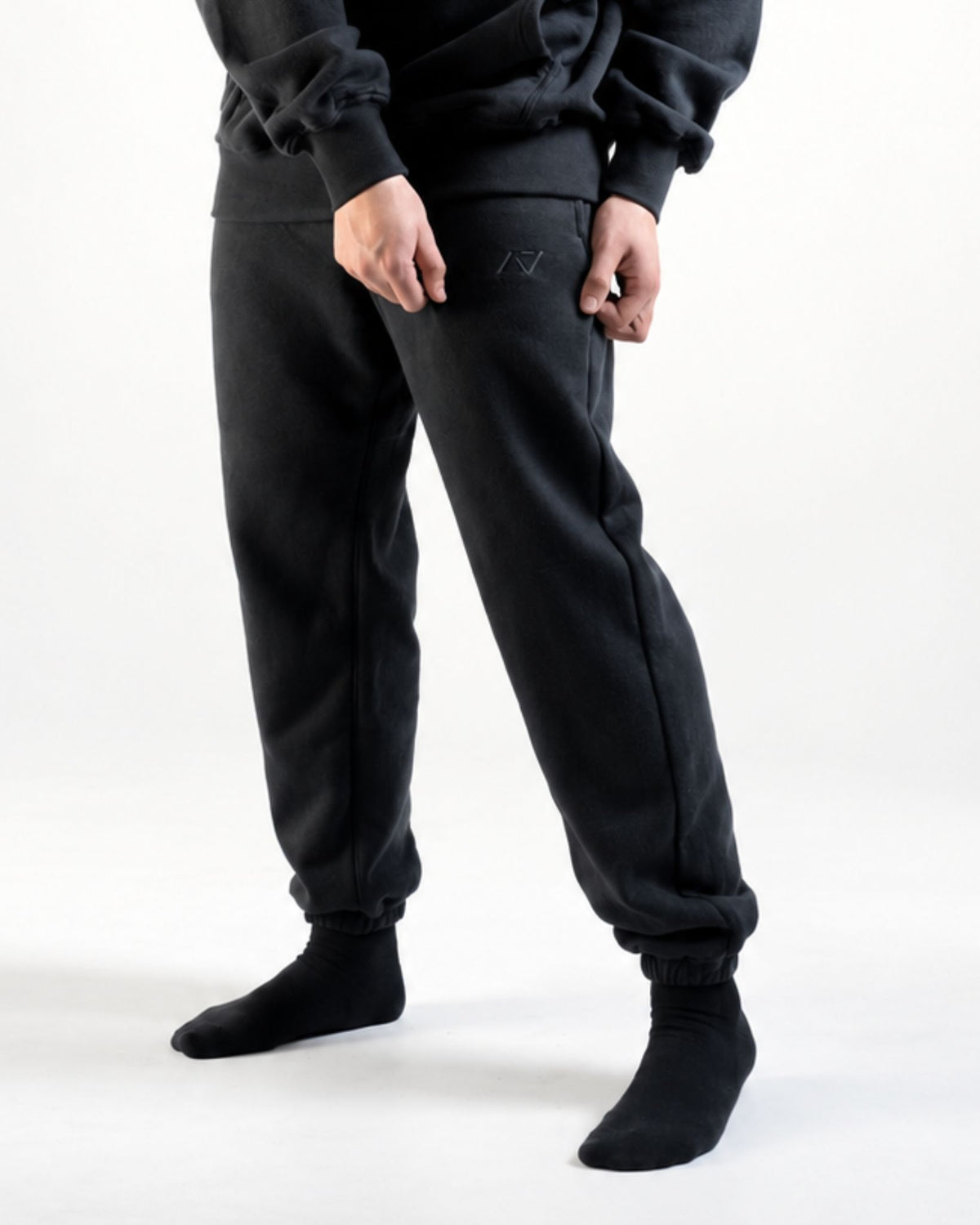 Front of the A7 Veil overfit joggers in stealth/black. Worn by a man and unisex sizing, this strength sports apparel is meet day apparel for traveling to meets and standing on the podium 