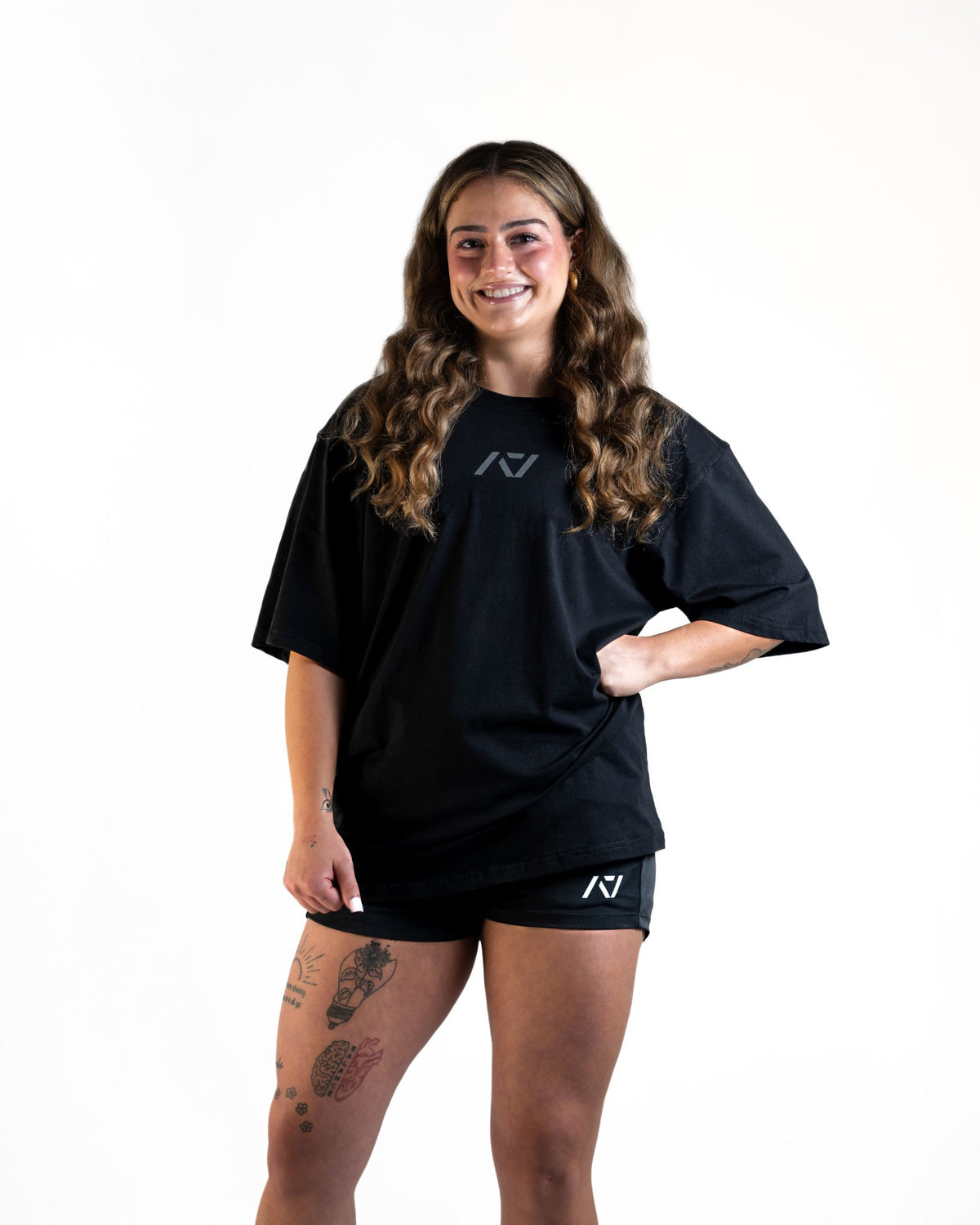 Front of the A7 Commands Overfit T-Shirt in black. Worn by a women and unisex sizing, this strength sports apparel is gym wear apparel for travelling to meets and standing on the podium 