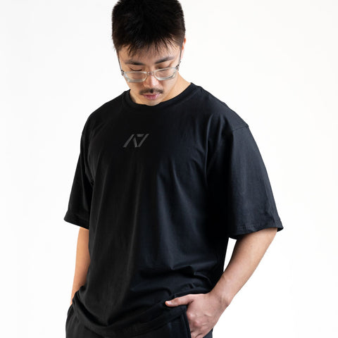 Front of the A7 Commands Overfit T-Shirt in black. Worn by a man and unisex sizing, this strength sports apparel is gym wear apparel for travelling to meets and standing on the podium 