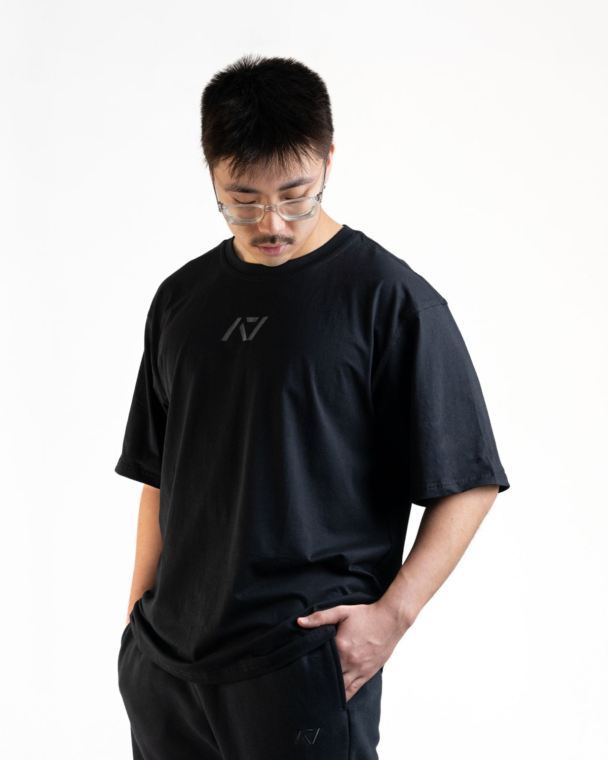 Front of the A7 Commands Overfit T-Shirt in black. Worn by a man and unisex sizing, this strength sports apparel is gym wear apparel for travelling to meets and standing on the podium 