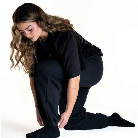 Front of the A7 Veil overfit joggers in stealth/black. Worn by a women and unisex sizing, this strength sports apparel is meet day apparel for traveling to meets and standing on the podium 