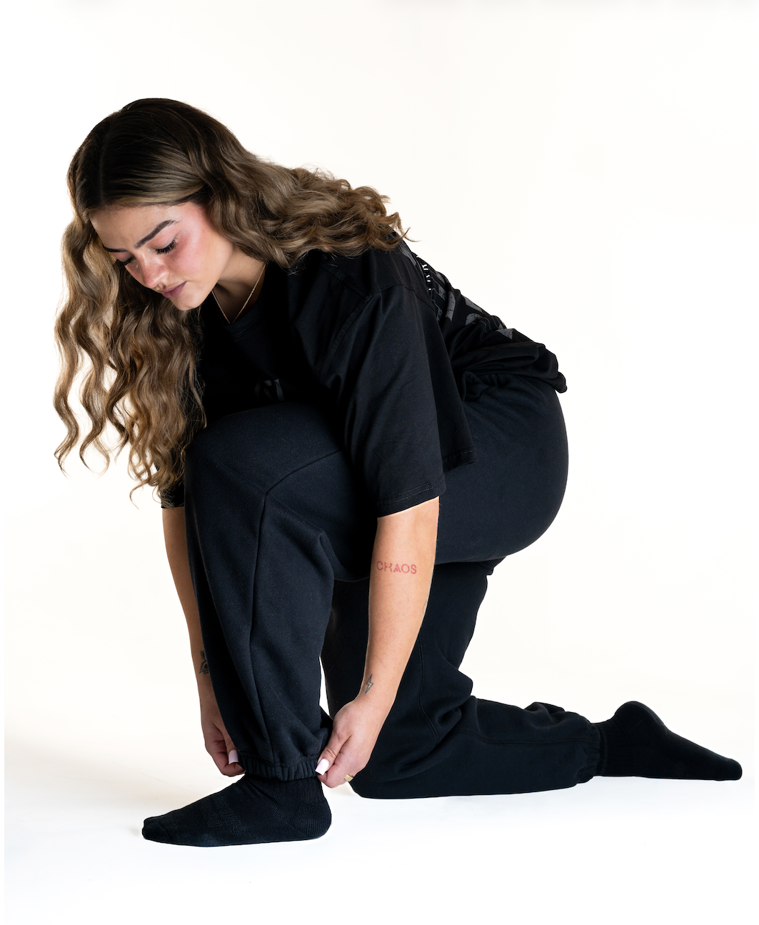 Front of the A7 Veil overfit joggers in stealth/black. Worn by a women and unisex sizing, this strength sports apparel is meet day apparel for traveling to meets and standing on the podium 