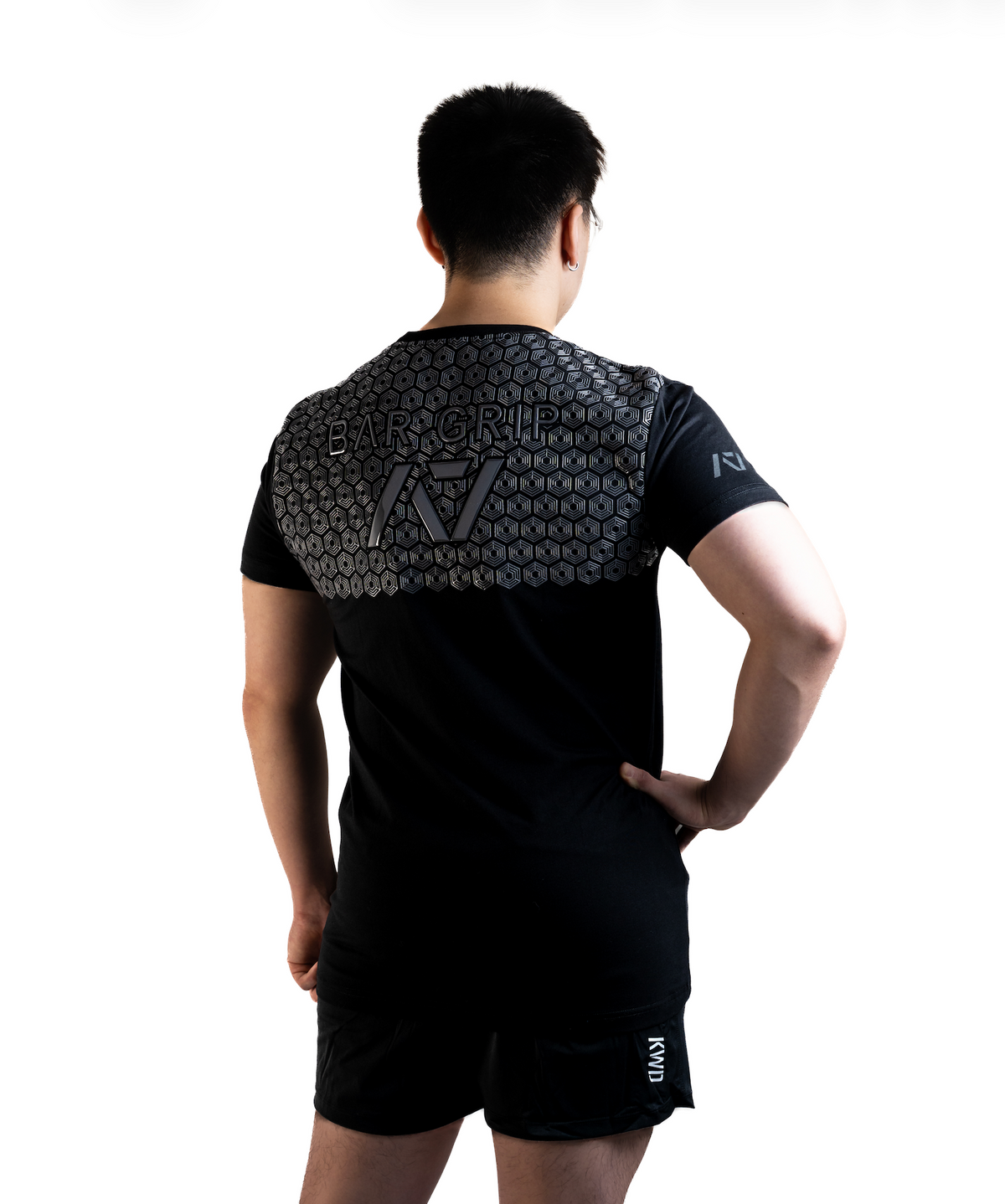 Back View Man wearing A7's Bar Grip High Standards Low Bar Black shirt. Back view showing the A7 Bar Grip used for squatting and benching in commercial gyms without chalk. Paired with black KWD 360 GO shorts made from a stretchy squat proof material to use in powerlifting training