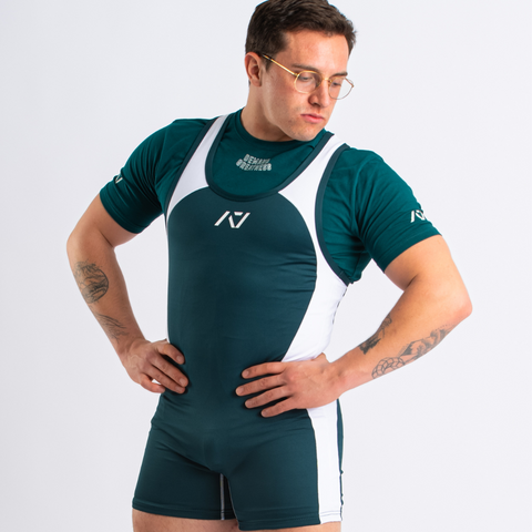 Front view of man wearing green and white IPF approved emerald singlet and emerald A7 Meet t-shirt in green and white. White A7 logo on green material with white straps and side panels. The white and green A7 powerlifting singlet is made with premium materials and flatlock seams for maximum comfort on competition platform. The Men'sluno singlet features curved panel design for a slimming look on the IPF competition platform. 