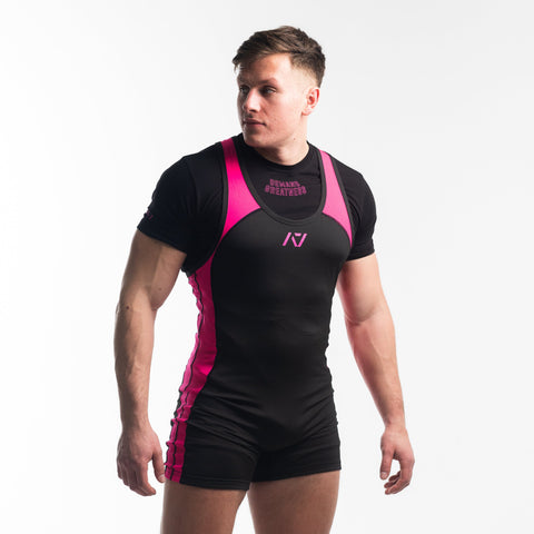 Front view of Man wearing black and pink IPF approved flamingo singlet and flamingo A7 Meet t-shirt in black and pink. Pink A7 logo on black material with pink straps and side panels. The pink and black A7 powerlifting singlet is made with premium materials and flatlock seams for maximum comfort on competition platform. 
