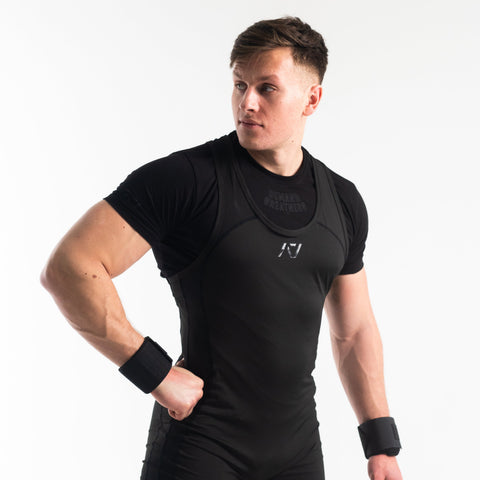 Front view of man wearing black IPF approved singlet and black A7 Meet t-shirt in stealth colourway. Black A7 logo on black material. The black A7 powerlifting singlet is made with premium materials and flatlock seams.
